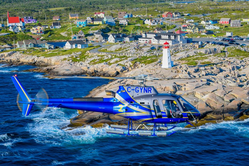 Nova Scotia Department of Natural Resources and Renewables' H125 helicopter flying over Cape Breton Island in Nova Scotia