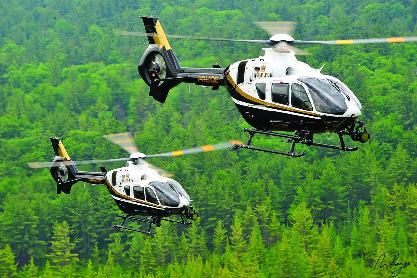 Ontario Provincial Police flies two Airbus H135 helicopters over forest in Canada